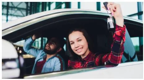 woman-in-car-after-getting-keys-out-of-it Happy woman with her keys after car unlocked for her